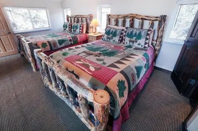 a bedroom with two beds in a room at Lazy R Cottages- 16A cabin in Estes Park