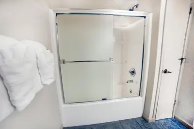 a shower with a glass door in a bathroom at Sunnyside Knoll- 6 cabin in Estes Park