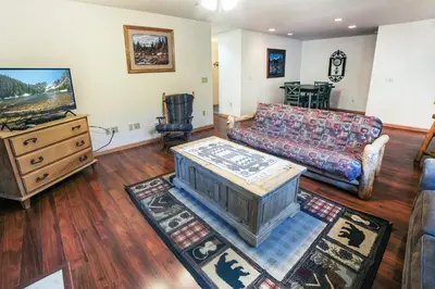 a living room with a couch and a tv at Sunnyside Knoll- 6 cabin in Estes Park