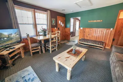 a living room with a table and a dining room at Lawn Lane B - #3383 in Estes Park