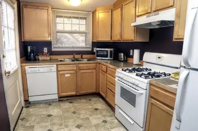 a kitchen with white appliances and wooden cabinets at Lawn Lane B - #3383 in Estes Park