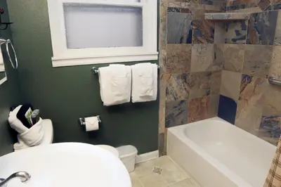 a bathroom with a tub and a toilet and a sink at Lawn Lane B - #3383 in Estes Park