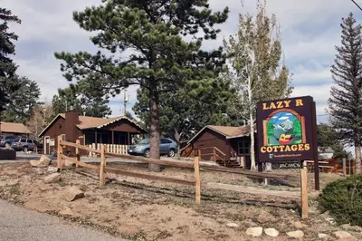 a sign for a restaurant with a building at Lazy R Cottages- 1 apts in Estes Park