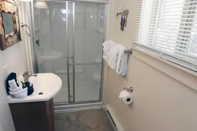 a bathroom with a shower and a sink at Triple R Cottages- 5 cabin in Estes Park