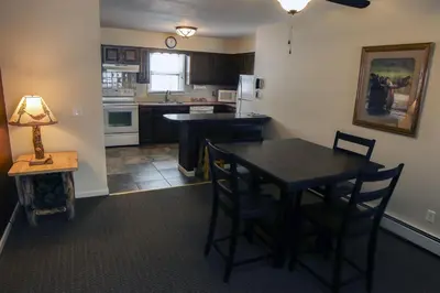a kitchen with a table and a table and chairs at Fawn Valley Inn- 304 condo in Estes Park