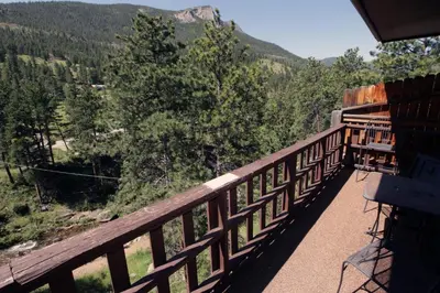 a balcony with a view of the mountains at Fawn Valley Inn- 304 condo in Estes Park