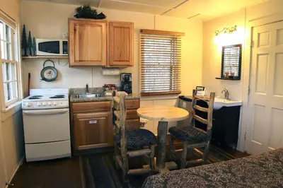 a small kitchen with a table and a stove at Triple R Cottages- 7 cabin in Estes Park