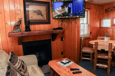 a living room with a fireplace and a tv at Lazy R Cottages- 2 cabin in Estes Park
