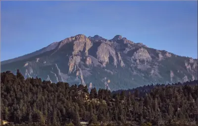 a large mountain with trees in front of it at Lazy R Cottages- 2 cabin in Estes Park