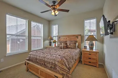 a bedroom with a bed and a ceiling fan at Ski-In Granby Getaway in Granby