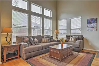 a living room with a couch and a coffee table at Ski-In Granby Getaway in Granby