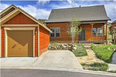 a house with a large garage in front of it at Ski-In Granby Getaway in Granby