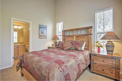 a bedroom with a bed and a table with a lamp at Ski-In Granby Getaway in Granby