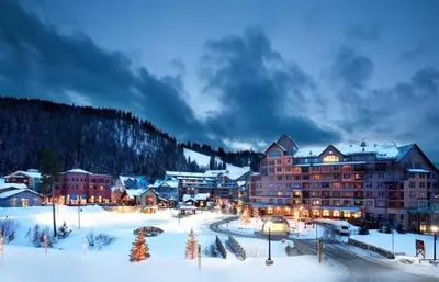 a resort in the snow at night at Ski-In Granby Getaway in Granby