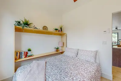 a bedroom with a bed and a shelf with plants at Alpine Vista Haven in Silverthorne