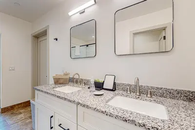 a bathroom with two sinks and a mirror at Alpine Vista Haven in Silverthorne