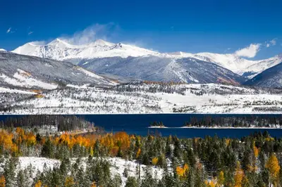 a view of a snowy mountain range with a lake at Alpine Vista Haven in Silverthorne