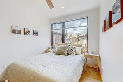 a bedroom with a bed and a large window at Alpine Vista Haven in Silverthorne