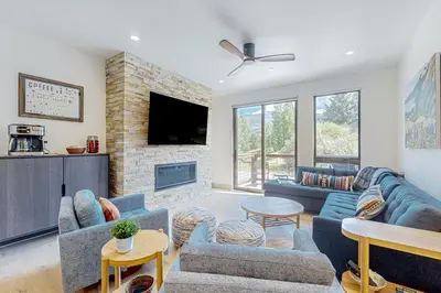 a living room with blue couches and a fireplace at Alpine Vista Haven in Silverthorne