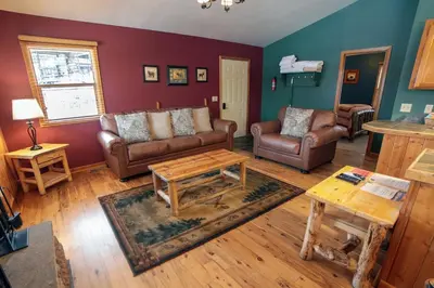 a living room with couches and a coffee table at Lazy R Cottages- 17 cabin in Estes Park