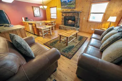 a living room with a couch and a fireplace at Lazy R Cottages- 17 cabin in Estes Park