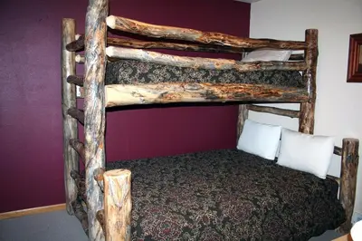 a couple of bunk beds in a room at Lazy R Cottages- 17 cabin in Estes Park