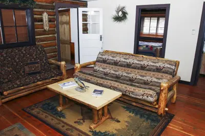a living room with a couch and a coffee table at Triple R Cottages- 1 cabin in Estes Park
