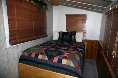 a small bedroom with a bed in a room at Triple R Cottages- 1 cabin in Estes Park