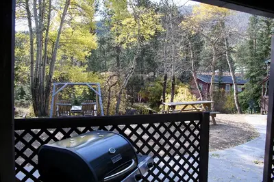 a television on a fence with a view of a backyard at Fawn Valley Inn- 253 apts in Estes Park