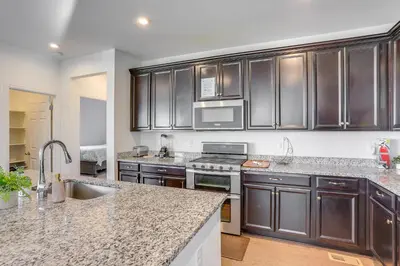 a kitchen with stainless steel cabinets and granite counter tops at Near Rocky Mountain Arsenal Commerce City Home in Henderson