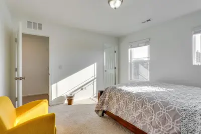 a bedroom with a bed and a yellow chair at Near Rocky Mountain Arsenal Commerce City Home in Henderson