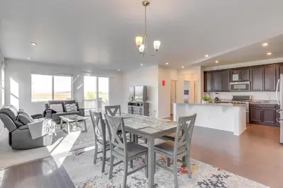 a kitchen and living room with a table and chairs at Near Rocky Mountain Arsenal Commerce City Home in Henderson