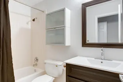 a bathroom with a toilet and a sink and a mirror at 1 Mi to Dtwn Stylish Denver Home with Patio in Denver