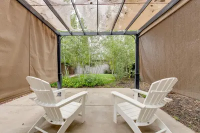 two white chairs sitting on a patio in a tent at 1 Mi to Dtwn Stylish Denver Home with Patio in Denver
