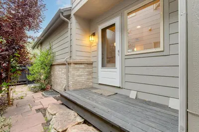 a house with a wooden porch with a door at 1 Mi to Dtwn Stylish Denver Home with Patio in Denver