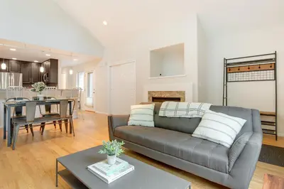 a living room with a couch and a table at 1 Mi to Dtwn Stylish Denver Home with Patio in Denver