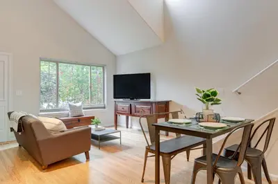 a living room with a table and chairs and a tv at 1 Mi to Dtwn Stylish Denver Home with Patio in Denver
