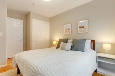 a bedroom with a large white bed with two lamps at 1 Mi to Dtwn Stylish Denver Home with Patio in Denver