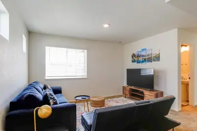 a living room with a couch and a flat screen tv at 9 Mi to Airport Pet-Friendly Aurora Home with Deck in Aurora