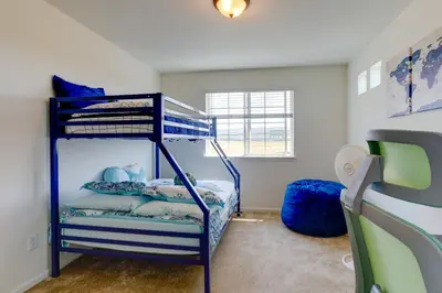 a bedroom with two bunk beds in a room at 9 Mi to Airport Pet-Friendly Aurora Home with Deck in Aurora
