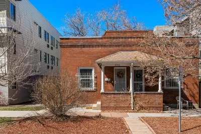 a red brick building with a door in a yard at HOT TUB Firepit Pool Table Patio Cozy Downtown Denver in Denver
