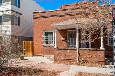 a brick house with a front door and a no parking sign at HOT TUB Firepit Pool Table Patio Cozy Downtown Denver in Denver