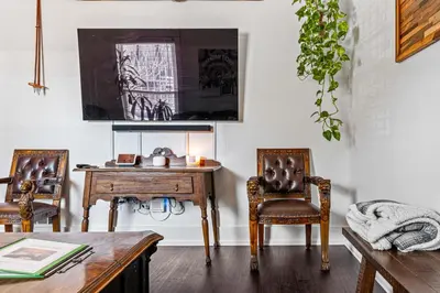 a dining room with a table and two chairs at HOT TUB Firepit Pool Table Patio Cozy Downtown Denver in Denver