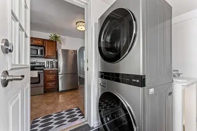 a laundry room with a washer and dryer at HOT TUB Firepit Pool Table Patio Cozy Downtown Denver in Denver