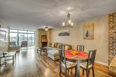 a living room with a table and a couch at 2 BR Condo Heart of LoDo w/Great View/Amenities in Denver