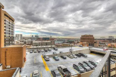 a parking lot with cars parked in a city at 2 BR Condo Heart of LoDo w/Great View/Amenities in Denver