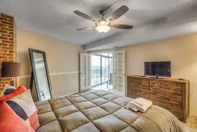 a bedroom with a large bed and a ceiling fan at 2 BR Condo Heart of LoDo w/Great View/Amenities in Denver