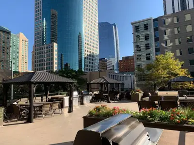 a patio with tables and chairs in a city at 2 BR Condo Heart of LoDo w/Great View/Amenities in Denver