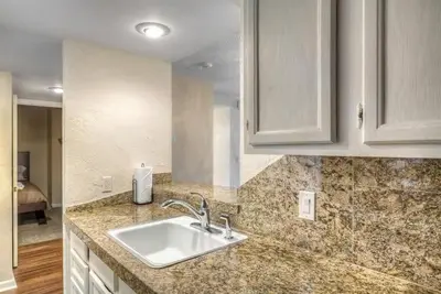 a kitchen with a sink and a counter top at 2 BR Condo Heart of LoDo w/Great View/Amenities in Denver