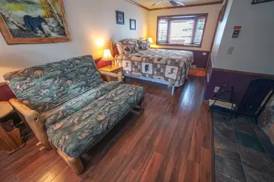a living room with a couch and a bed at Sunnyside Knoll- 1 studio in Estes Park